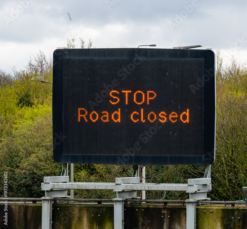 STOP - Road Closed. A motorway overhear matrix sign on a UK Manchester advising motorists the motorway is closed due to an incident.