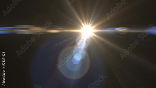 Bright Lens Flare Effect with Hexagonal Bokeh and Light Streaks on Black Background