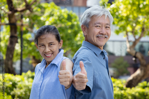 Happy smiling healthy Asian senior couple, old husband and wife showing approving, passing, good, yes, go for it, good to go, two thumbs up or double thumbs up hand gesture