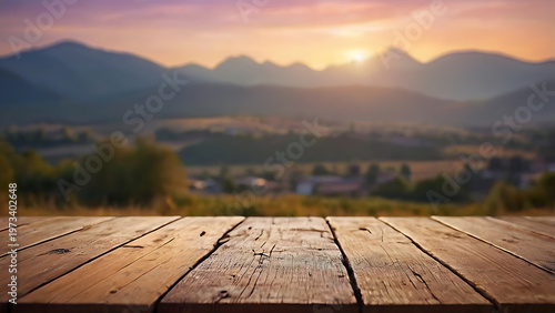 Wooden table with beautiful lake and mountain landscape under colorful sunset sky