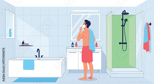 Young man grooming himself by shaving his beard with a razor in a bright modern bathroom equipped with a shower and bathtub.