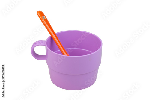 Cup with handle and spoon for a small child. Tableware made of recycled plastic. Ecological concept. Isolate on a white background.