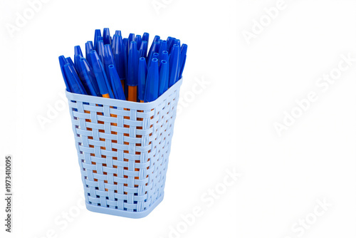 Square plastic basket with ballpoint pens for writing. Tableware made of recycled plastic. Ecological concept. Isolate on white background.