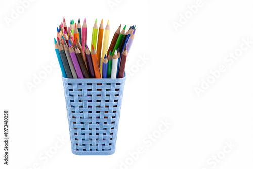 Square plastic basket with colored pencils for drawing. Office supplies made of recycled plastic. Ecological concept. Isolate on white background.