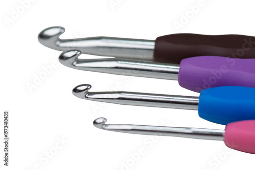 A collection of colorful crochet hooks, isolated on a white background. Close-up photo.