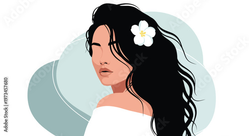 Beautiful portrait of a woman with long flowing black hair and a white tropical flower tucked behind her ear in a soft style.