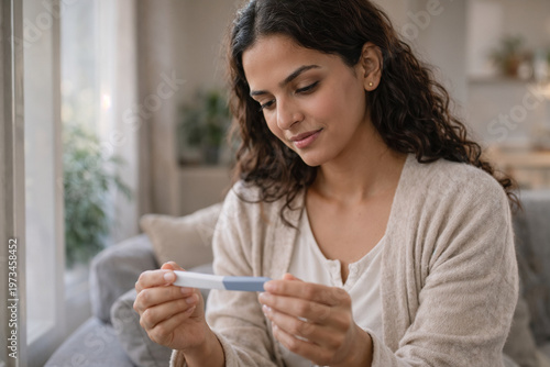 Woman holding pregnancy test at home emotional health and life moment