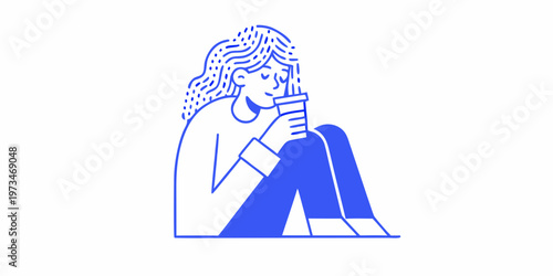 Woman thoughtfully embraces her knees while holding a warm beverage