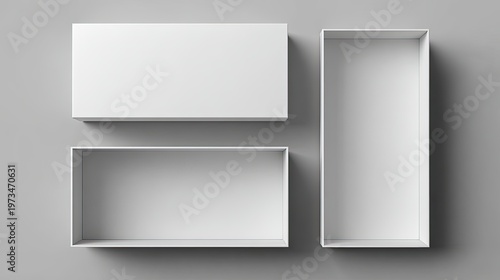 Three white rectangular boxes, one closed, arranged on a neutral background