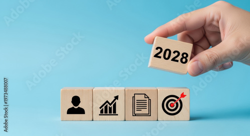 hand holding wooden block with 2028, business planning and strategy