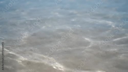 Gentle Ripples on a Sandy Seabed Under Sunlight.