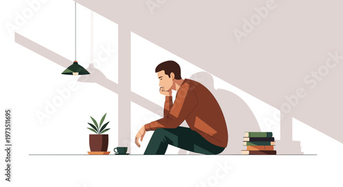 A pensive man sits on the floor in a minimalist room while long window shadows stretch across the wall near a potted plant and stacked books.