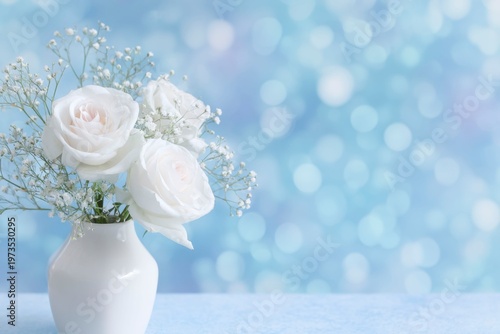 abstract background with white roses and baby breath flowers in a vase, pastel blue bokeh lights of a birthday party banner