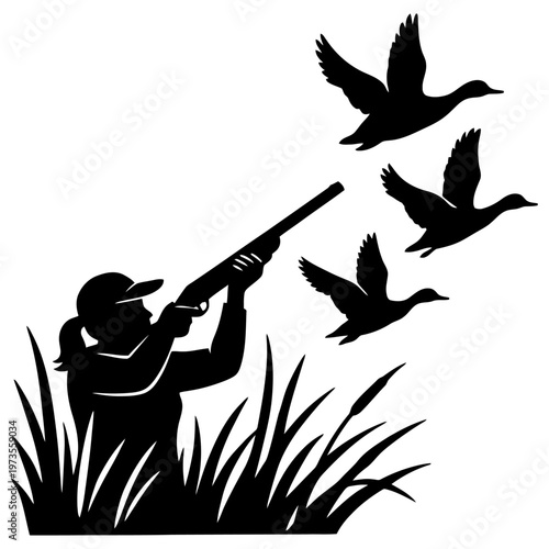 Black silhouette of a female hunter aiming her shotgun at a flock of flying wild ducks during an outdoor activity in the tall marsh grass