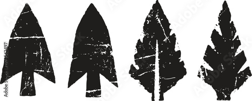 Four black prehistoric stone arrowheads in different leaf shaped styles ancient tools illustration