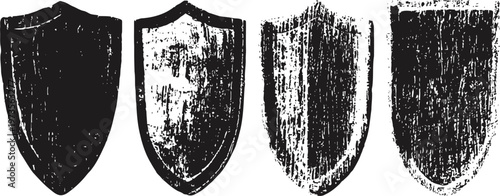 Set of four distressed black medieval shield silhouettes with various worn textures and shapes