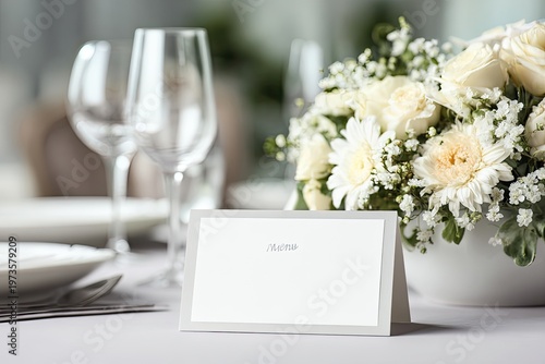 Elegant Wedding Place Setting with Floral Arrangement and Name Card.
