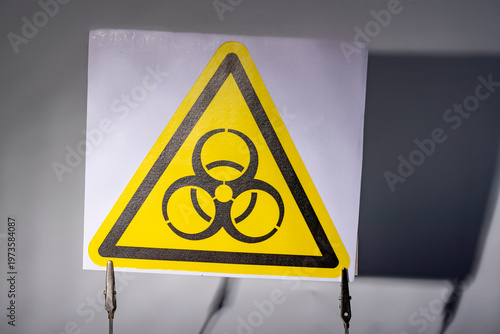 Warning sign shows radiation symbol in bright yellow with black markings for safety precautions in hazardous areas
