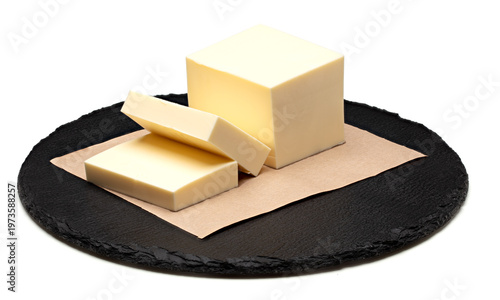 Pieces of butter on paper isolated on white background. clipping path