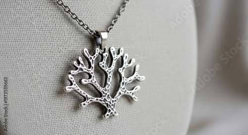Silver Tree Pendant Necklace on Gray Fabric Background, Jewelry