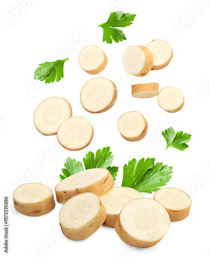 sliced horseradish root with parsley isolated on white background. clipping path