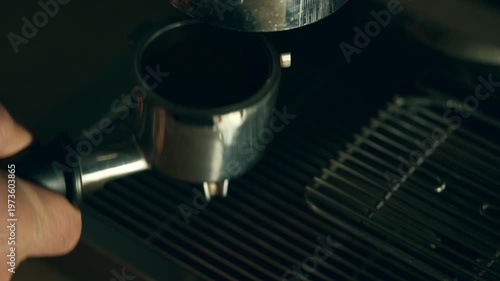 Inserting a portafilter into an espresso machine