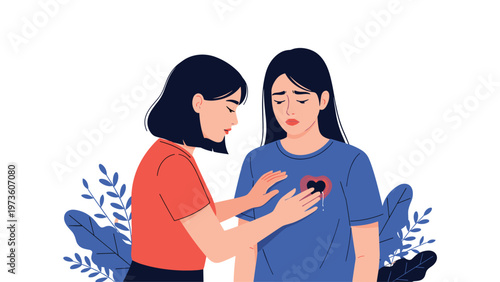 Empathetic woman placing her hands on her friends chest to comfort her as she cries with a visible broken heart icon on her blue t-shirt.