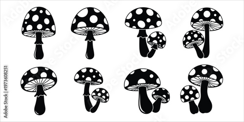 A collection of stylized amanita mushrooms in black and white