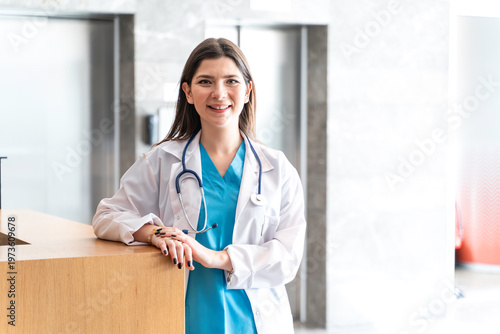 Female doctor or nurse standing at hospital reception desk