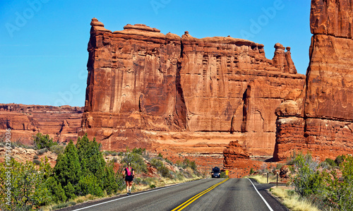 Jogger runs along a road inside Utah's Arches National Park