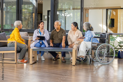 Senior group nursing care nurse wheelchair conversation support retirement community Senior group retirement community with nursing care as nurse leads warm conversation and support meeting bright