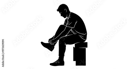 Silhouette of a man sitting and tying his shoelaces preparing for activity.