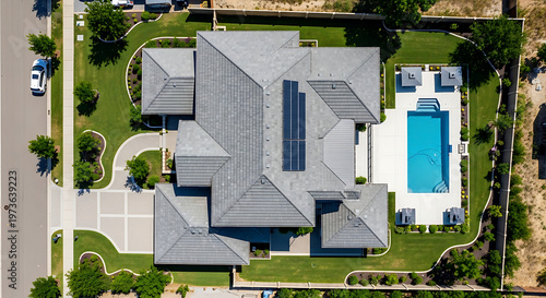 Aerial View of Modern House with Solar Panels and Swimming Pool