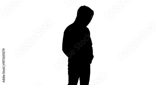 Silhouette of a person standing with head bowed in contemplation.