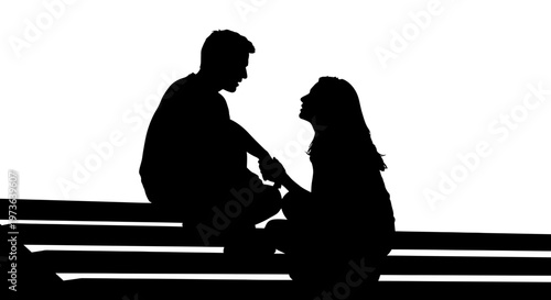 Silhouette of romantic couple sitting together.