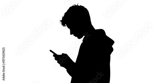Silhouette of young man engrossed in his smartphone.