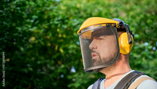 Принти на полотні Bearded man wearing adjustable gardening safety helmet with mesh visor and ear muffs