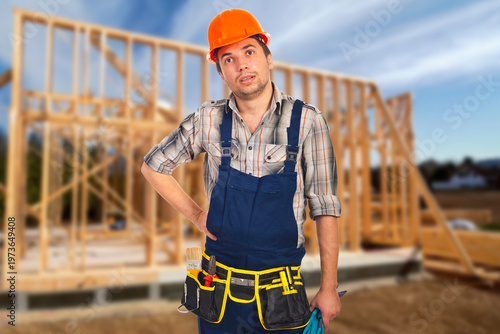 Εκτύπωση καμβά Worker stands proudly in front of wooden frame structure