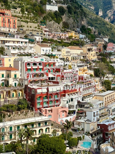 Colorful hillside buildings in Positano on the Amalfi Coast, showcasing layered Mediterranean architecture, lush greenery, and iconic Italian seaside charm.
