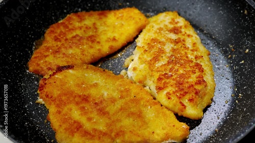 Frying breaded fish. Frying breaded fish. Frying flounder. Prepared crispy golden cutlets waiting to be served with care. Fried golden patties sizzle and patiently wait to impress diners