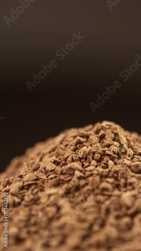 Close up of instant coffee granules rotating on black background