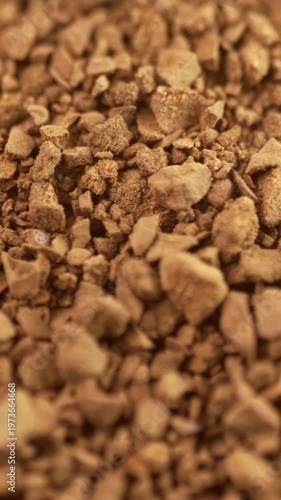 Macro shot of rotating background made of brown instant coffee granules