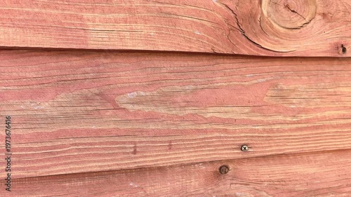 Close-up view of textured wooden surface showing natural grains and patterns at sunny outdoor location