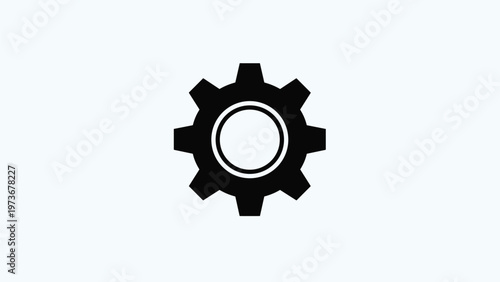 Bold black icon of a mechanical gear or cogwheel centered on a light blue background, representing industrial settings and machinery concepts.