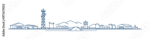 Runway centered with control tower and radio mast near mountains