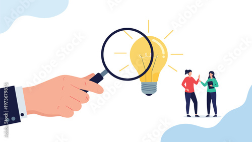 Magnifying glass examines glowing light bulb as two business women discuss ideas in background for creative innovation.
