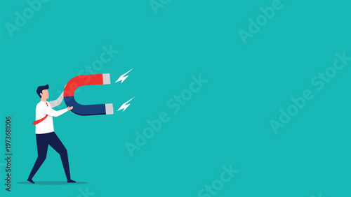 Professional man holding a large red and blue horseshoe magnet pointing towards the right side of a turquoise background.