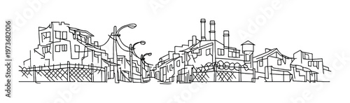 Industrial buildings and fenced street with lamp posts