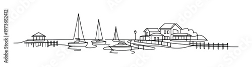 Boats moored near waterfront houses and docks at marina