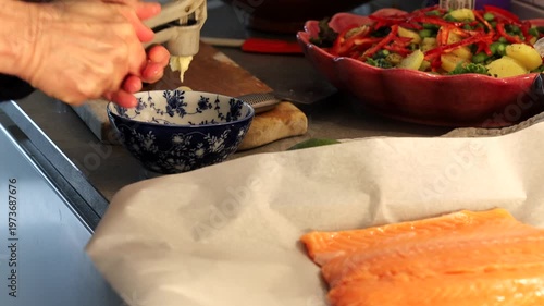 Stockholm, Sweden A cook prepares a side of salmon in a domestic kitchen for a dinner party.